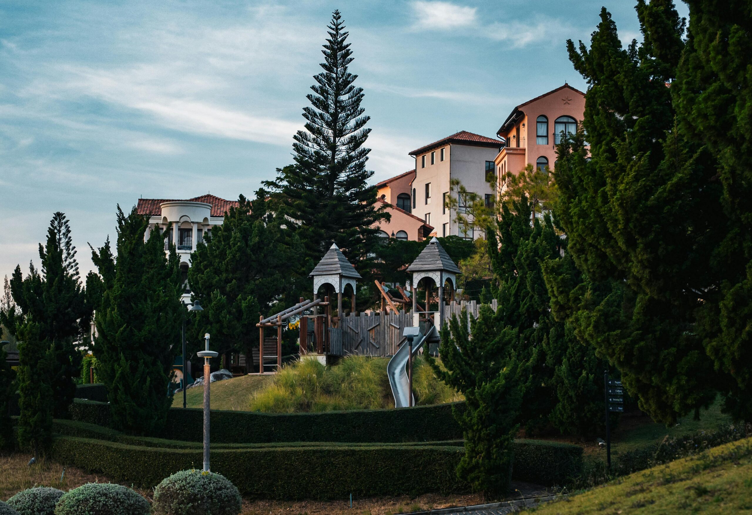 Scenic view of Italian-inspired architecture surrounded by lush greenery in Thailand.
